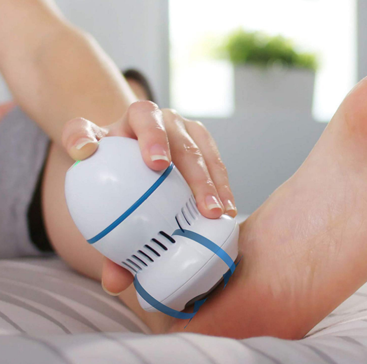 Hand gliding the electric callus remover over the heel