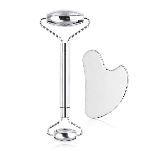 Glowly stainless-steel face roller and heart-shaped gua sha on a white background