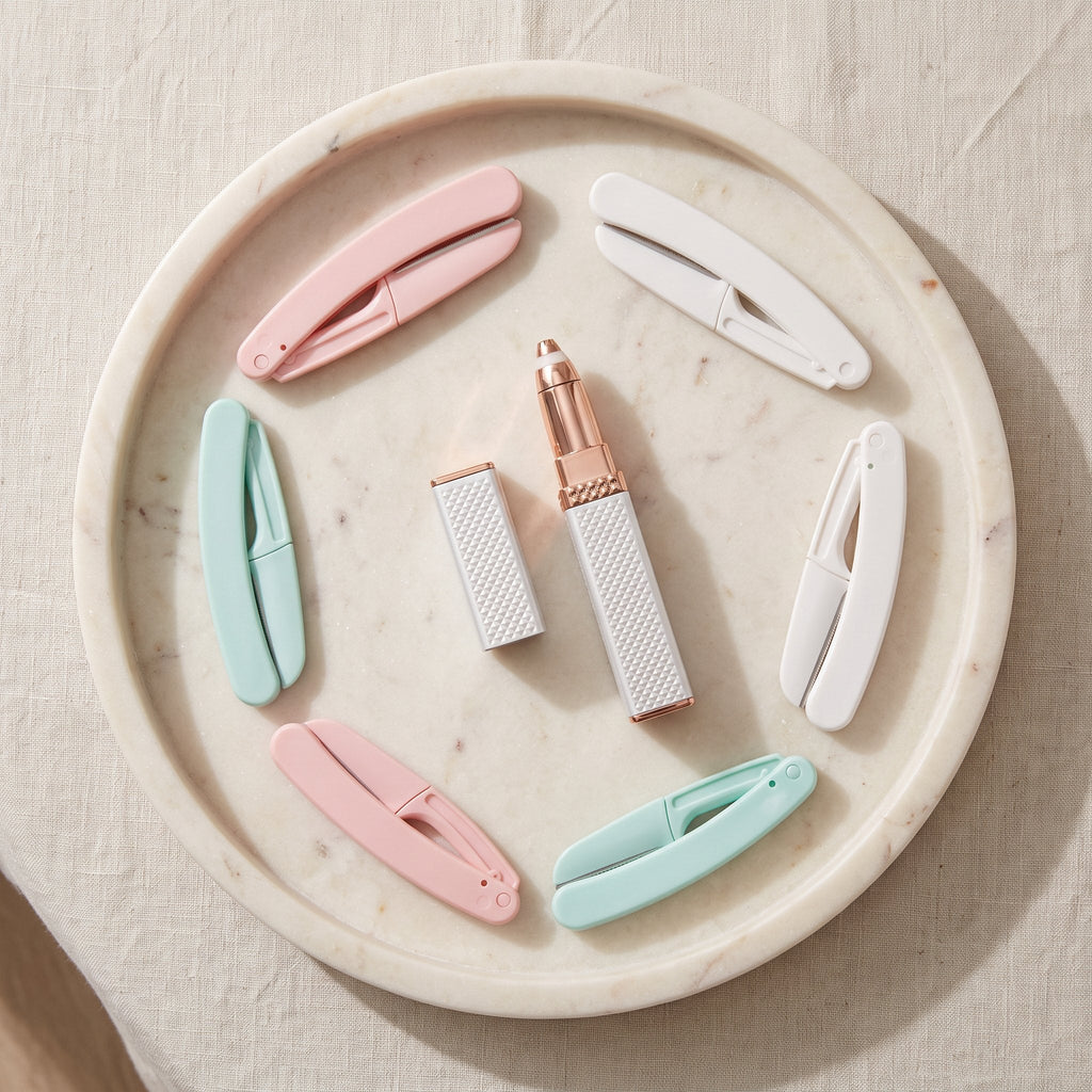 Smooth Face Set: hair remover pen and six folding face razors on a marble tray