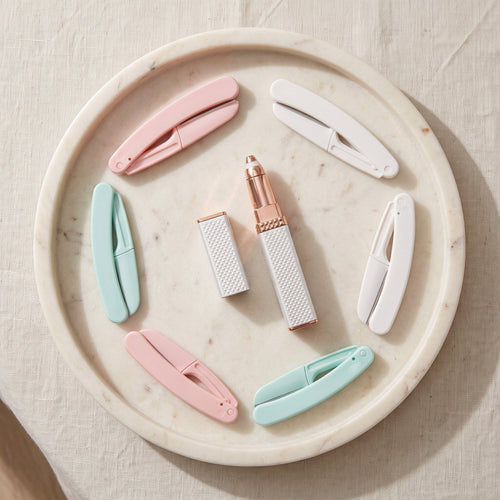 Smooth Face Set: hair remover pen and six folding face razors on a marble tray